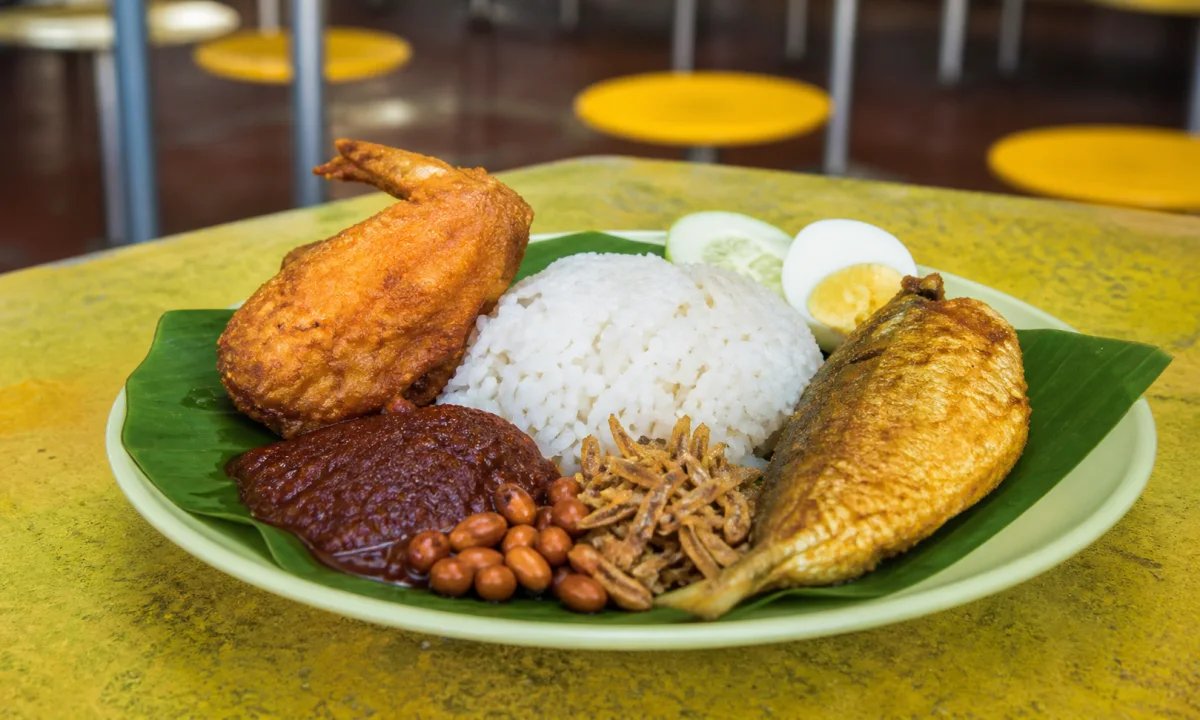 Nasi lemak with coconut rice, fried chicken, egg, ikan bilis, peanuts, cucumber and sambal